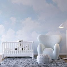 a baby's room with a chair, crib and stuffed animals