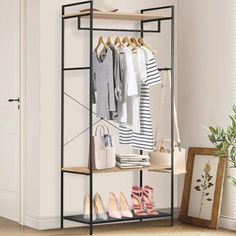 a rack with shoes and handbags hanging on it in front of a white wall