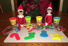 the elf on the shelf is playing with play - doh and other items that he has made