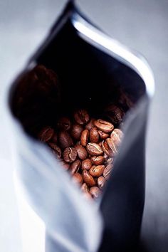 a blender filled with coffee beans on top of a table