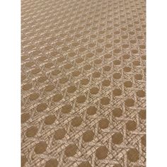 an area rug with circles and squares on the ground, in brown tones that appear to be made from woven fabric