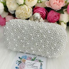 This luxurious encrusted pearl bridal clutch never fails to turn heads with its understated elegance and classic design. Adorned with varying sized ivory pearls and enhanced with a large creamy pearl clasp, this bridal clutch is the very picture of refinement. This elegant bridal clutch features rose gold trim, attachable chain and large enough for your phone. Complete your list of must-have wedding accessories with the ultimate bridal accessory to finish off your look and storing your wedding d Pearl Purse, Pearl Clutch Bag, Bridal Clutch Bag, Purse Wedding, Beaded Clutch Bag, Pearl Clutch, Wedding Handbag, Clutch Bag Wedding, Bridal Purse