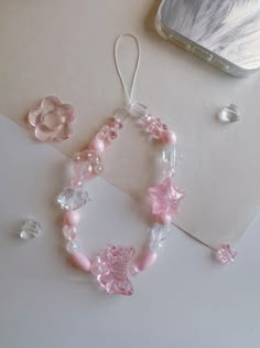 a pink bracelet and earring sitting on top of a table