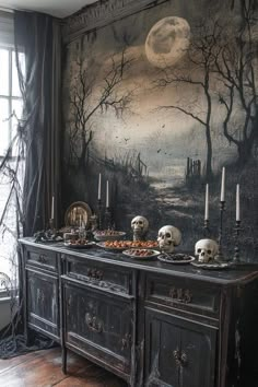 an old dresser with skulls on it in front of a halloween scene painted on the wall