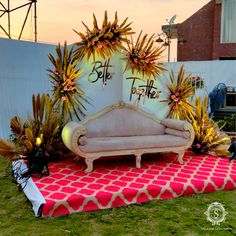 a couch sitting on top of a lush green field