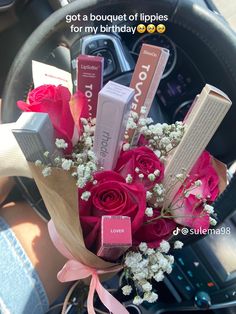 a bouquet of lipstick and flowers in a car steering wheel with the text, i got a bouquet of lippies for my birthday