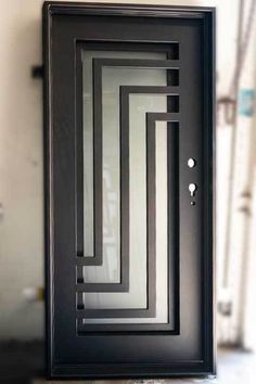 a black door with white and grey lines on it's side, in front of a building