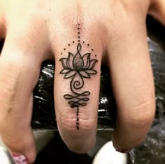 a person's hand with a tattoo on it and a flower in the middle