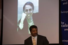 a man standing in front of a projection screen