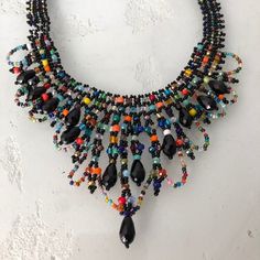 19" Iridescent Beads In A Draped Chandelier Necklace Design Black, Multi-Color Glass Bead Necklace With Shimmering Iridescent Beads Easy To Open Magnetic Clasp Because Of The Handmade Nature; No Two Necklaces Are Exactly The Same A Gorgeous Necklace Made In Guatemala Using Artisan Crafted Czech Glass Beads. Czech Glass Beads Are Know World Wide For Their Quality. Principles Of Fair Trade Are Upheld. Please Visit Our Posh Closet For Complete Enchanted Line: Necklaces,Bracelets & Earrings Bohemian Black Crystal Necklaces With Colorful Beads, Bohemian Black Crystal Necklace With Colorful Beads, Black Crystal Necklaces With Colorful Beads For Jewelry Making, Multicolor Beaded Crystal Necklace For Party, Bohemian Black Crystal Necklaces With Round Beads, Bohemian Black Crystal Necklace For Party, Adjustable Black Crystal Necklaces With Colorful Beads, Adjustable Black Crystal Necklace With Colorful Beads, Black Beaded Necklace With Dangling Beads As Gift