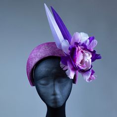 This stunning purple halo headband fascinator is the perfect finishing touch for any occasion. Handcrafted from high-quality materials, it features a purple sinamay base, delicately adorned with feathers, flowers, and a beautiful pearl and crystal centerpiece. The band is covered in a soft, comfortable fabric to ensure a secure and comfortable fit for all-day wear. Whether you're attending a wedding, a day at the races, or a special event, this headband fascinator is sure to turn heads and add a Adjustable Purple Headband For Spring, Adjustable Purple Hair Accessories For Summer, Purple Adjustable Headband For Spring, Adjustable Purple Mini Hat Headband, Purple Spring Formal Costume Hats And Headpieces, Purple Headpiece With Handmade Flowers For Kentucky Derby, Purple Headband With Handmade Flowers, Purple Handmade Flowers Fascinator For Party, Purple Handmade Flowers Headpiece For Kentucky Derby