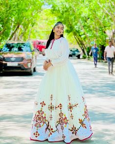 This Habesha Kemis is a true masterpiece of traditional Ethiopian fashion, with its exquisite Menen fabric and intricate Tilf design. The Menen fabric is renowned for its softness and durability, making this Kemis not only beautiful but also comfortable to wear. The Tilf design is intricate and delicate, with a pattern that is both modern and traditional, with clean lines and bold shapes that create a unique and eye-catching look. The Tilf design extends down the front of the Kemis, creating a v Ethiopian Fashion, Eritrean Dress, Habesha Dress, Habesha Kemis, Traditional Jewelry, A Pattern, Clean Lines, Formal Event, The Eye