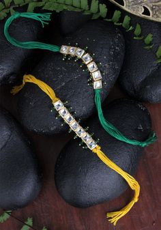 some black rocks with green and yellow tassels