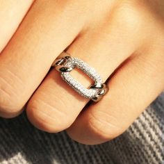 Pave Chain Ring ✨💎 Linked Together #staychic, stay connected! ✨ Heavy Rhodium plating over Sterling Silver Top Grade 5A Cubic Zirconia Diamond Alternatives Finished with a platinum look 15,000+ customer reviews Free Shipping & Returns *Learn more Customization is welcomed 👍 Recommendations As an everyday ring As a travel wedding band ✈ As a gift for your soulmate ❤️ 💎 Features From the French word meaning "to pave", our silver band is paved with multiple round cubic zirconia. Inspired by chai Elegant Silver Rings With Adjustable Chain, Elegant Silver Ring With Adjustable Chain, Silver Open Ring Chain Fine Jewelry, Elegant Silver Chain Ring, Silver Tarnish-resistant Chain Promise Ring, Silver Fine Jewelry Chain Ring Gift, Silver Diamond Ring That Is Tarnish Resistant, Silver Tarnish Resistant Diamond Ring, Silver Tarnish-resistant Chain Ring