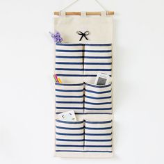 an over the door hanging storage bag with two pockets for books, magazines and other items