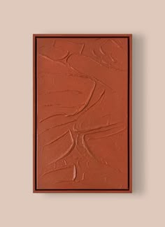 a painting on the wall that is red and has some brown paint in front of it