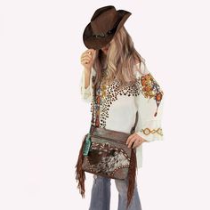 "Step into the wild side of style with our Western-Boho Cowhide Crossbody Shoulder Bag. Each bag is a statement of individuality, featuring a bold hand-tooled leather pattern, accented with a vibrant design, and finished with playful tassels that sway with your every move. Handcrafted with care, this tote marries the raw beauty of cowhide with the refined detail of tooled leather. The result is a bag that's as unique as its carrier - no two patterns are exactly alike, making your tote a one-of-a Bohemian Multicolor Bags For Fall, Bohemian Multicolor Fall Bags, Bohemian Fall Bags With Tassels, Bohemian Shoulder Bag For Fall, Bohemian Shoulder Bag With Tassels For Fall, Bohemian Bags With Adjustable Strap For Fall, Bohemian Brown Shoulder Bag For Fall, Western Brown Bag With Fringe, Brown Western Bag With Fringe