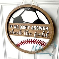 a wooden sign that says if we don't answer check the field, baseball