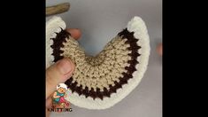 someone is crocheting the top part of a knitted toothbrush holder in brown and white