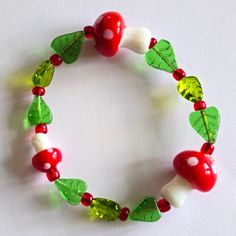 I Handmade This Bracelet Using Glass Mushroom Beads And Glass Leaf Beads, Strung On Strong And Stretchy Elastic Cord. Colors Are : Fits A Small Wrist Best See Photo Next To Quarter For Size Reference Ships Fast! Goosi8388jw3b5l2 Beaded Forest Forestcore Cottage Cottagecore Fungus Fungi Mycology Women's Hand Crafted Aminata Spotted Spots Polka Dot Jewelry Goblincore Accessories, Mushroom Bracelet, Goblin Fairy, Mushroom Beads, Goblincore Fairycore, Mushroom Jewelry, String Crafts, Leaf Beads, Handmade Jewelry Bracelets