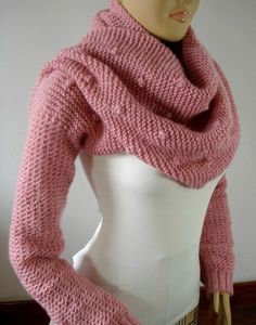 a mannequin wearing a pink sweater and scarf