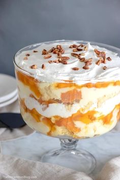 a trifle with whipped cream and pecans on top