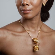 African American Model Wearing Helen Necklace - 14k Gold Plated - Iza By Silvia D’Avila one of a kind, off the runway jewelry & wearable art - handcrafted in NYC Modern Yellow Gold Brass Jewelry, Modern Yellow Gold Jewelry, Elegant Brass Necklaces With Unique Variations, Elegant Brass Necklace With Unique Variations, Modern Handmade Gold-plated Jewelry, Contemporary Gold Hallmarked Jewelry, Contemporary Hallmarked Gold Jewelry, Elegant Pendant Jewelry With Unique Design, Modern Gold-tone Brass Jewelry