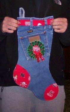 a person is holding up a pair of jeans with christmas decorations on the bottom and sides