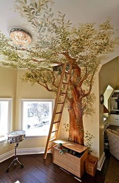 a room with a tree painted on the ceiling and ladder up to it's top