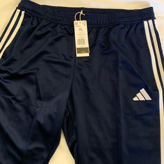 Blue Adidas Comfortable Athletic Pants With Zippers On Pockets And Lower Legs. Blue Wide Leg Sports Bottoms, Adidas Sports Bottoms With Side Pockets, Blue Sports Pants With Pockets, Adidas Blue Sweatpants For Sports, Adidas Sports Trousers, Blue Sports Bottoms With Three Stripes, Navy Sports Bottoms With Three Stripes, Adidas Blue Joggers For Sports, Adidas Sporty Blue Bottoms