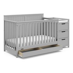 a white crib with drawers underneath it