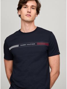 Tommy Hilfiger men's T-shirt. Made from lightweight cotton jersey, known for its breathability and stretch, our comfortable crewneck tee is cut in an easy fit and finished with our Tommy Stripe graphic.  Material: 100% Cotton. Modern Crew Neck T-shirt With Text Print, Tommy Hilfiger Graphic Print Crew Neck T-shirt, Adidas Cotton T-shirt With Three Stripes, Adidas Cotton Short Sleeve T-shirt, Cotton T-shirt With Three Stripes Branding, Crew Neck, Adidas Cotton Crew Neck T-shirt, Tommy Hilfiger Cotton Logo T-shirt, Modern Branded Crew Neck T-shirt, Graphic Tee With Three Stripes, Crew Neck