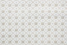 a white and brown wallpaper with an intricate design on it's surface,