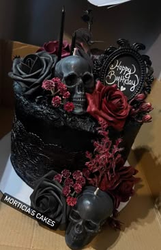 a birthday cake decorated with skulls and roses