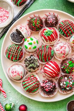 a white plate topped with lots of different types of chocolate covered cookies and candies