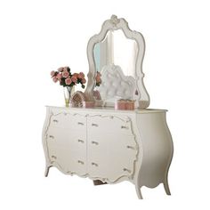 a white dresser with flowers and a mirror