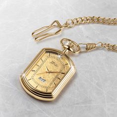 The pocket watch is a classic, elegant style. It has been around for hundreds of years and remains timeless and classy—the ultimate status symbol for men. A fancy rectangular case is set with a 24k gold foil dial that is sure to impress. A single solitaire Diamondeau®, flawless simulated diamond sits at 12 o’ clock and handy date window to keep you on track. Get yourself a piece of history with this gold foil pocket watch. Luxury Elegant Pocket Watch With Polished Finish, Classic Gold Watch With Rectangular Dial, Formal Yellow Gold Watch Accessories With Rectangular Dial, Classic Gold Business Watch, Classic Gold Watches For Business, Timeless Engraved Business Watch, Classic Gold Watches With Subdials, Rectangular Yellow Gold Watch Accessories For Formal Occasions, Luxury Gold Watches For Formal Occasions