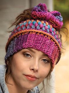 a woman wearing a colorful knitted hat