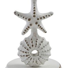 a starfish figurine sitting on top of a white cake covered in frosting