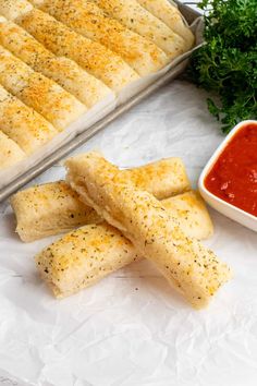 bread sticks with sauce and parsley on the side