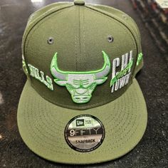 the chicago bulls snap back hat is green and has an embroidered bulls head on it