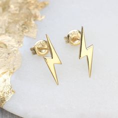 PRODUCT DESCRIPTION * 'Bowie' inspired mini lightning bolt earrings. * A matching necklace is available to create the perfect gift. * Available in plain sterling silver, 18ct rose or yellow gold plated and pave crystal set sterling silver or rose gold. * The simplicity of this instantly recognisable symbol looks great! * We regret we are unable to exchange earrings for hygiene reasons GIFT PACKAGING * These earrings come in a free Hurleyburley pouch, or you can pay £2 for a gift box. We can add Earring Card Design, Lightning Earrings, Bolt Earrings, Lightning Bolt Necklace, Unusual Necklace, Lightning Bolt Earrings, Earring Card, Unusual Earrings, Bold Earrings