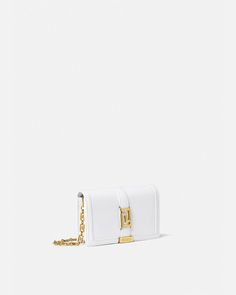 Versace Greca Goddess Mini Bag for Women | US Online Store White Evening Bag With Metal Logo, Formal White Bags With Metal Logo, Elegant White Shoulder Bag With Metal Logo, Elegant White Bags With Metal Logo, Elegant Crossbody Bag With Logo Hardware, Chic Wallet On Chain With Metal Logo For Everyday, Timeless Rectangular Wallet On Chain With Strap, Luxury White Rectangular Wallet On Chain, Elegant White Crossbody Wallet On Chain