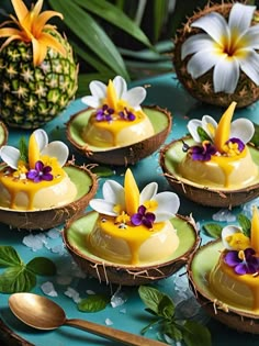 there are many desserts on the table with pineapples and flowers in them