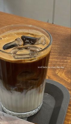 there is a drink with ice and chocolate in the glass on the table next to a piece of paper