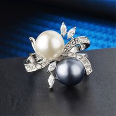 Elevate every outfit when you decorate your digits with this dazzling silvertone ring embellished with sparkling cubic zirconia. 0.91'' W Silvertone copper / cubic zirconia / imitation pearl