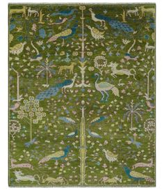 a green rug with birds and flowers on it