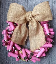 an image of a pink wreath made out of dynamites with a bow on it