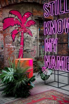 there is a neon sign that says still know my name