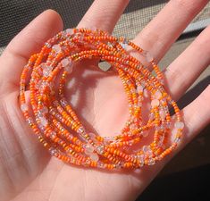 This listing is for a set of ten seed bead boho beaded bracelets. These orange and crystal confetti bracelets have dainty, tiny beads and bugle beads and are strung on strong elastic. They are double knotted and glued shut. These stackable bracelets would be cute friendship bracelets or gifts for best friends, gifts for her. Summer Gift Beaded Bracelets With Spacer Beads, Handmade Orange Beaded Bracelets As Gift, Handmade Orange Beaded Bracelets For Crafting, Handmade Orange Beaded Bracelets Spiritual Style, Dainty Beaded Bracelets With Round Beads For Festivals, Hand Wrapped Heishi Beads For Gift, Handmade Spiritual Orange Beaded Bracelets, Bohemian Orange Beaded Bracelets For Gifts, Bohemian Orange Beaded Bracelets As Gift